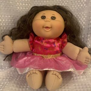 Cabbage Patch Kid with long brown Curley hair and brown eyes.